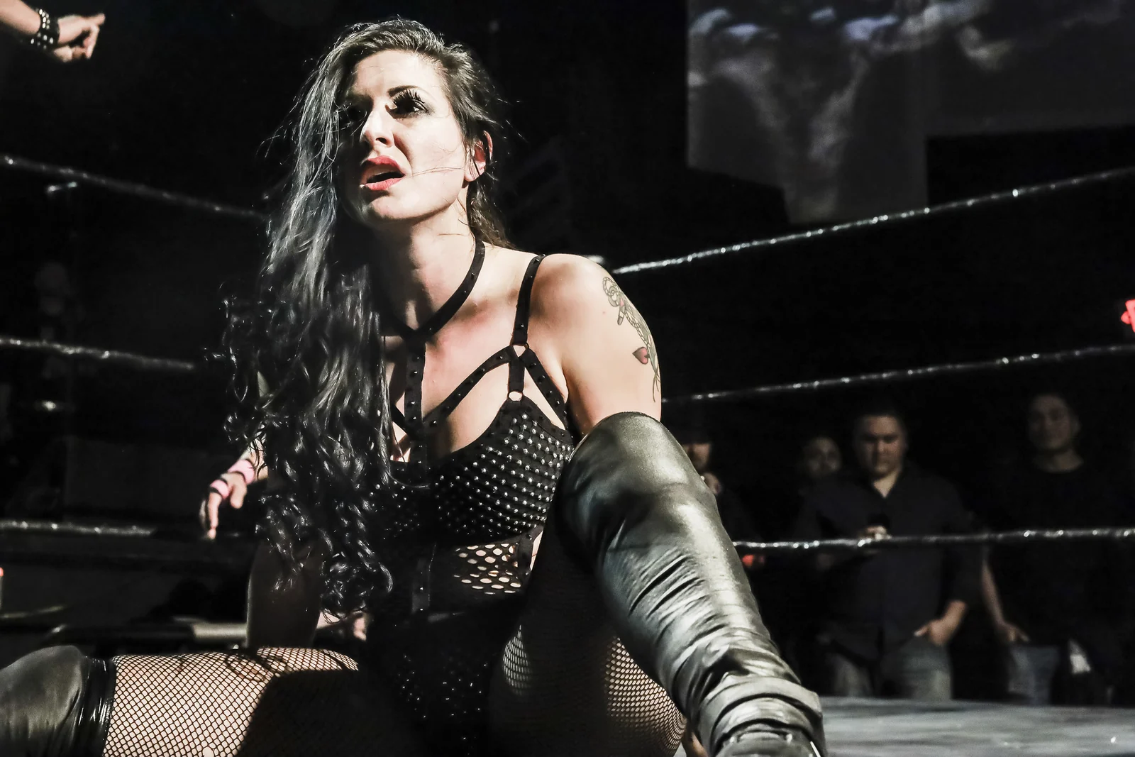 A wrestler sits in the ring during a WrestleCore event.