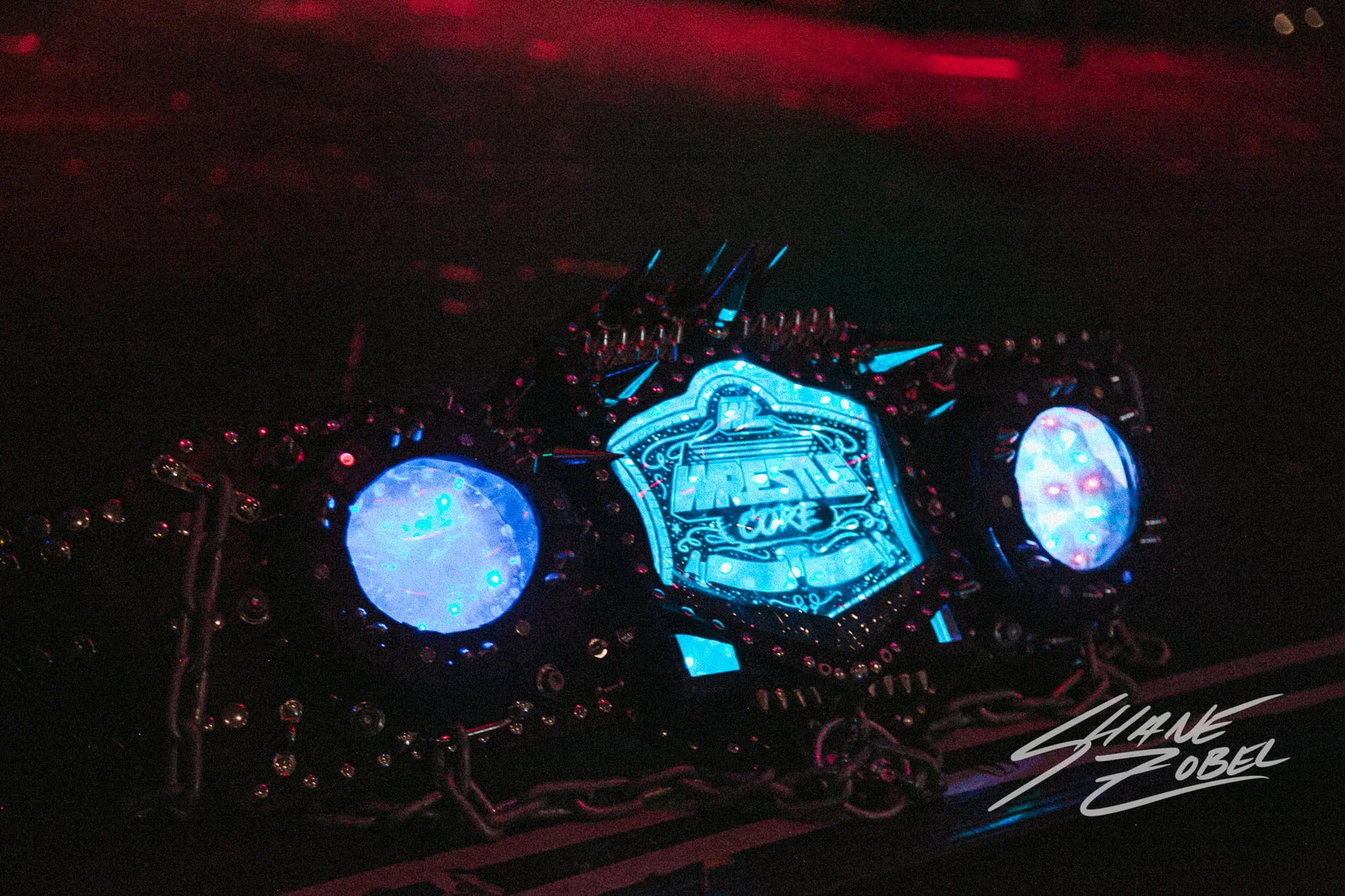 The WrestleCore Infinity Championship belt illuminated at a live show.
